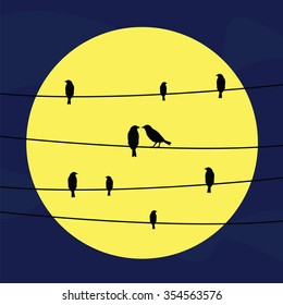 A silhouette of birds on wires at night in full moon light.