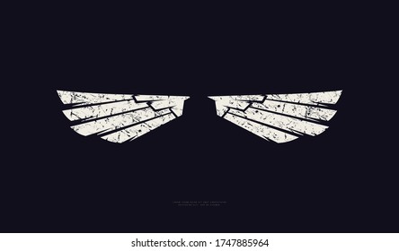 Silhouette of a bird's wings in military style. Design with rough texture