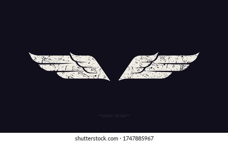 Silhouette of a bird's wings in sport style. Design with rough texture