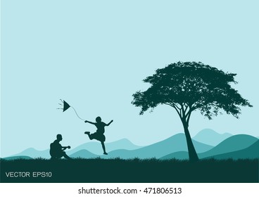silhouette of a boy playing guitar sister to dance.