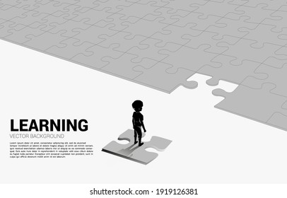 Silhouette of boy standing on route with jigsaw. Concept of education solution and future of children.