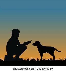 Silhouette of a boy training a dog during sunset