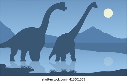 Silhouette of brachiosaurus lake with blue backgrounds