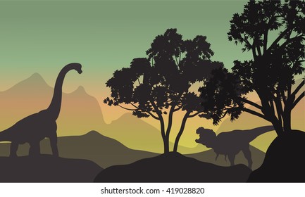 Silhouette of brachiosaurus and T-Rex in hills at the morning