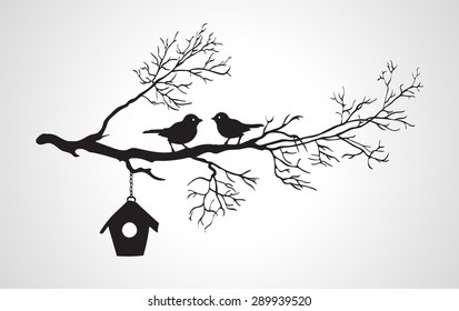 Silhouette of branches with two birds and starling house