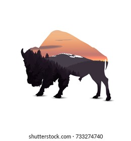 Silhouette of buffalo with panorama of mountains. 