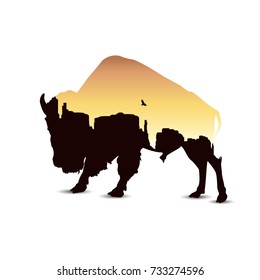 Silhouette of buffalo with western desert.