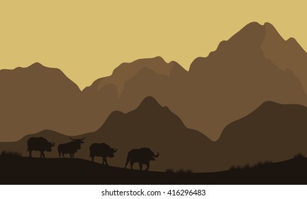 Silhouette of bull in mountain with brown background