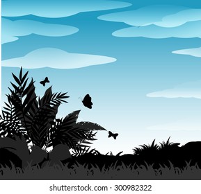 Silhouette bush and butterflies with blue sky background