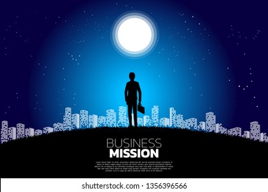 Silhouette of businessman with briefcase standing in the moon and star. Concept of business mission vision and goal.