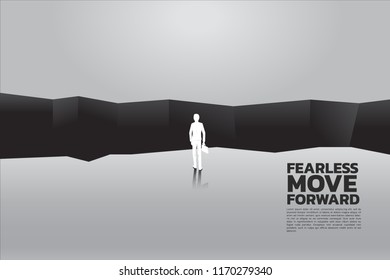silhouette of businessman with briefcase step forward to abyss. concept of business challenge and courage man