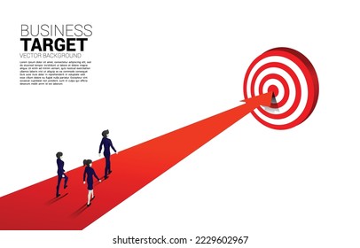 silhouette of businessman and businesswoman walking on arrow to center of dartboard. Business Concept of targeting and customer.Company vision mission.