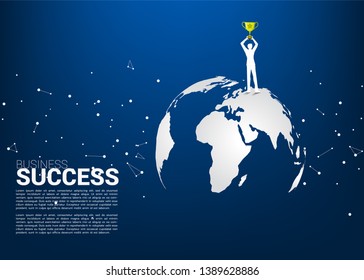 Silhouette of businessman with champion trophy standing on world map. Business Concept of international award winner.