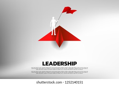 Silhouette of businessman with flag on origami paper airplane. Business Concept of leadership and vision mission.