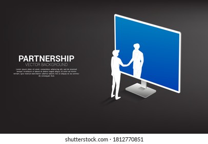 Silhouette of businessman  handshake from computer monitor. Concept of  digital business partnership and cooperation technology.