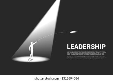 silhouette of businessman in highlight throw origami airplane. Concept of business market vision mission start up