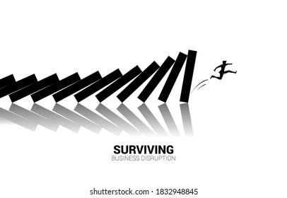 Silhouette of businessman  jump away from domino collapse. Concept of business industry disrupt 