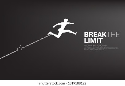 Silhouette of businessman jump to break the chain at foot. Concept of break the rule and limit in business.