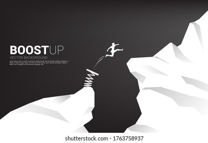 Silhouette of businessman jump over the gap with springboard. Concept of boost and growth in business.