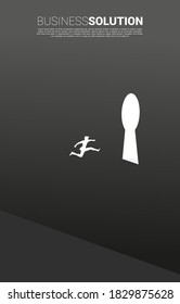 silhouette of businessman jumping to key hole exit on the wall. Find the solution concept vision mission and goal of business