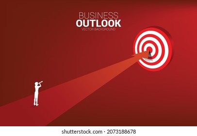 silhouette of businessman look through telescope standing on route to center dartboard. Business Concept of route to goal and direct to target.