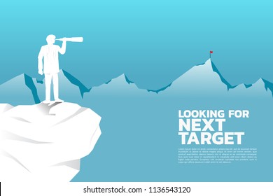 Silhouette of businessman looking through telescope to target on top of far mountain. business concept looking for next target and opportunity.