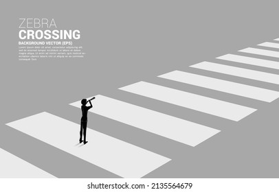 Silhouette of businessman looking through telescope standing on zebra crossing. Concept of safe zone and business road map.