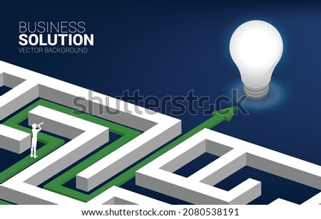 Silhouette of businessman looking through telescope on route path to exit the maze to light bulb. Concept for problem solving,solution strategy and idea.