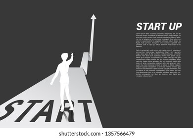 Silhouette of businessman point ahead from start line on growing graph. Concept of people ready to start career and business