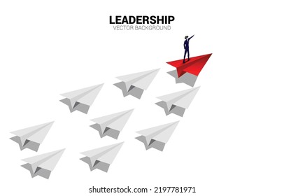 Silhouette of businessman point finger on origami paper airplane. Business Concept of leadership and vision mission.