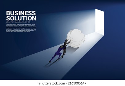 Silhouette of businessman pushing the rock to exit door. Concept of business challenge and work hard.