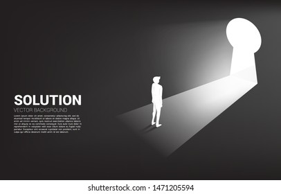 silhouette of businessman ready to move out to key hole door. Find the solution concept vision mission and goal of business