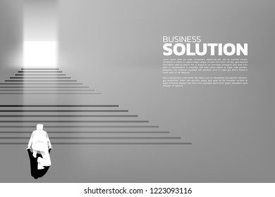 Silhouette of businessman ready to step up on stair to exit the door. Concept of people ready to up level of career and business solution.