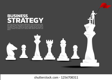 Silhouette of businessman with red flag on chess piece king. Business Concept of strategy planning and success