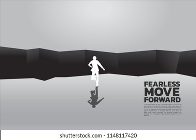 silhouette of businessman running to jumping over the gap. concept of business challenge and courage man