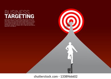 silhouette of businessman running on arrow to center of dartboard. Business Concept of targeting and customer.Company vision mission.