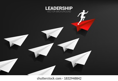 Silhouette of businessman running on red origami paper airplane leading group of white. Business Concept of leadership and vision mission.