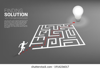 Silhouette of businessman running with route path to exit the maze to light bulb. Business concept for problem solving and finding idea.