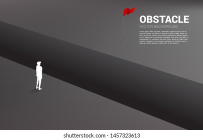 silhouette of businessman standing at abyss looking to goal. concept of business challenge and obstacle