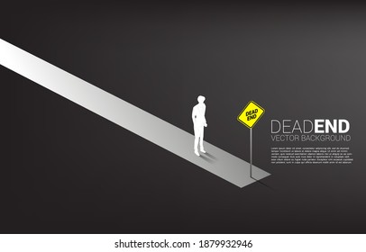 Silhouette businessman standing at the end of road with dead end signage  . Concept of wrong decision in business or end of career path. svg