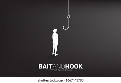 Silhouette of businessman standing with fishing hook. Concept of bait and hook in business. 