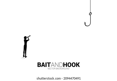 Silhouette of businessman standing looking through telescope with fishing hook. Concept of bait and hook in business.