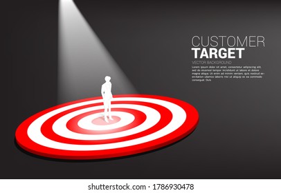 silhouette of businessman standing on center of dartboard with spot light . Business Concept of marketing target and customer.Company vision mission and goal.