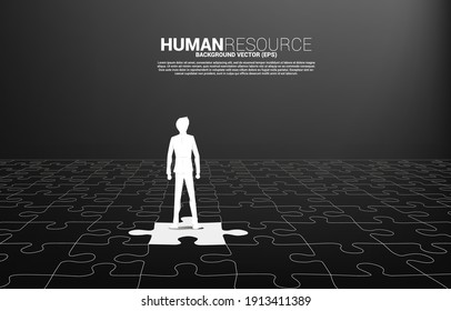 Silhouette of businessman standing on jigsaw piece. Concept of perfect job. Team recruitment. Human Resource. Put the right man on the right job concept.
