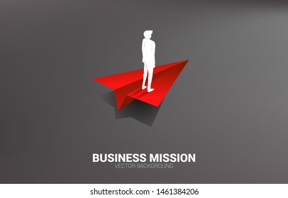 silhouette of businessman standing on red origami paper airplane. Business Concept of leadership, start business and entrepreneur