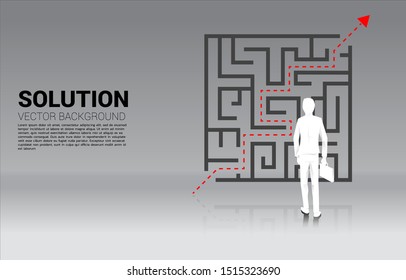 Silhouette of Businessman standing with plan to exit from maze . Business concept for problem solving and solution strategy