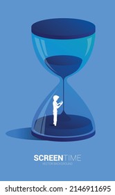 Silhouette of businessman use mobile phone standing with sand clock. Concept for mobile phone addict and screen.