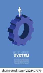 Silhouette of businessman walking on big gear. concept of business management and control