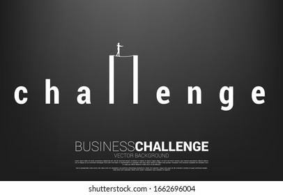 Silhouette of businessman walking on rope walk way on challenge wording.Concept for business risk and challenge in career path