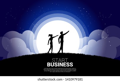 silhouette of businesswoman and business man point forward ahead at night. Concept of vision mission and entrepreneur